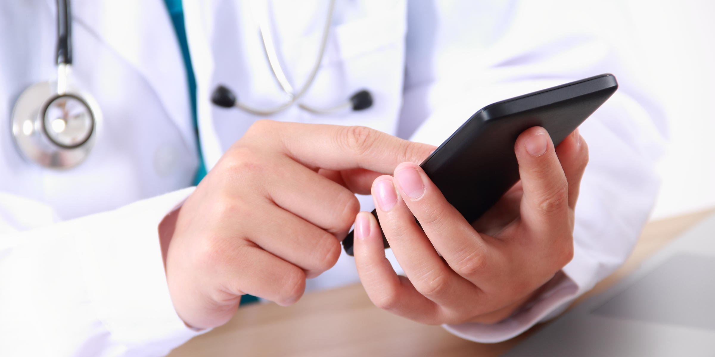 A provider using a mobile phone for their patient referral management.