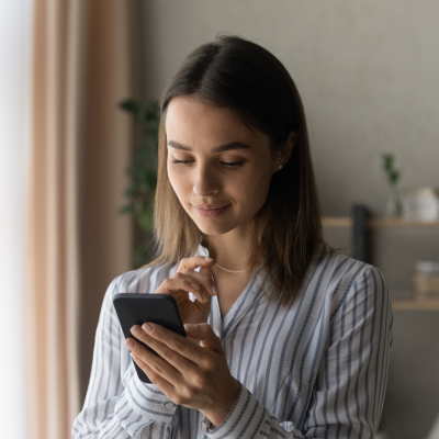 Patient using her phone where she can text her provider, leave a review or a voicemail with ease. 